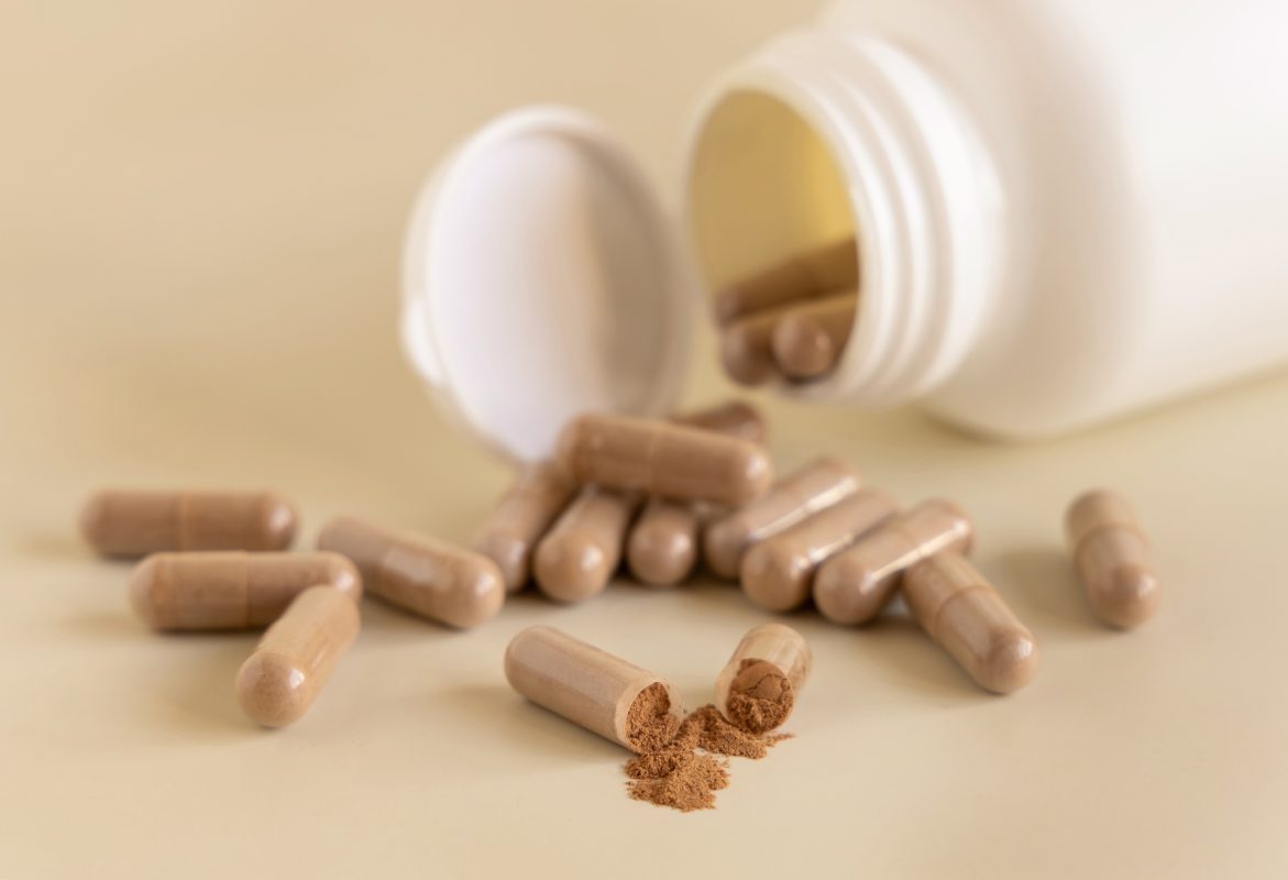 supplement capsules with brown powder